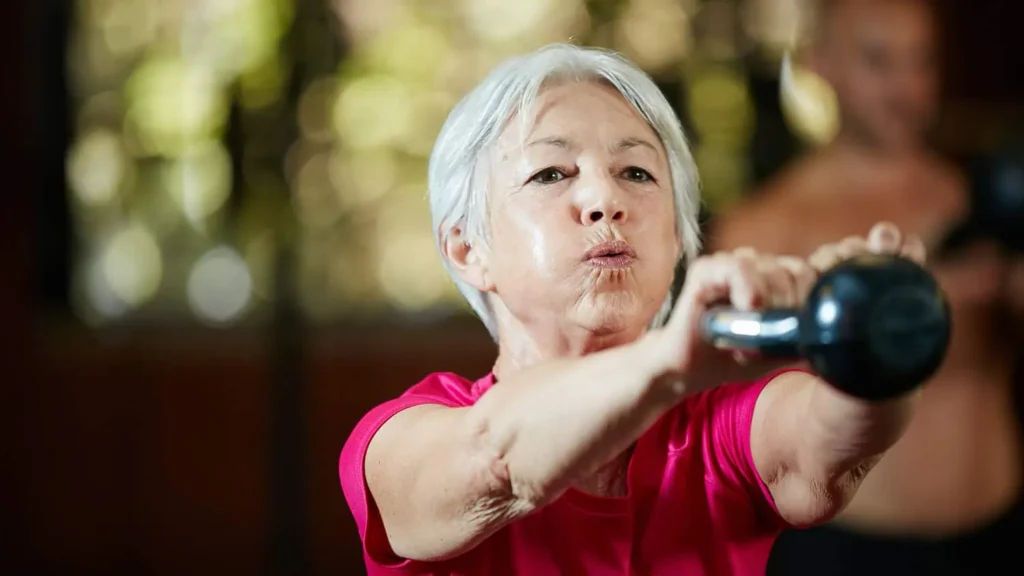 Toning Arms Without the Bulk: Is It Achievable? 1 Woman doing resistance band exercises for toned arms Harwich