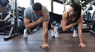 Image of man and woman doing Cardio Harwich to tone their arms. 